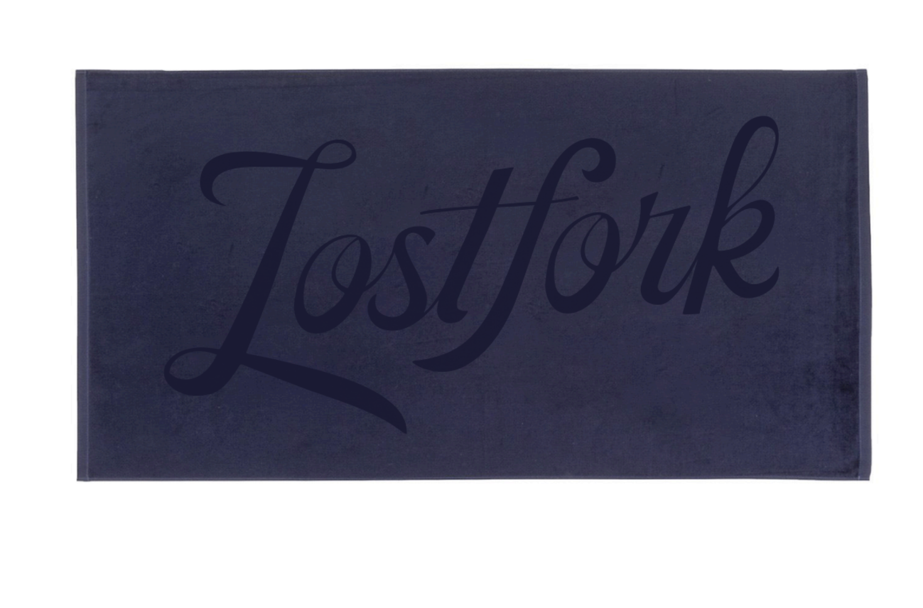 A dark blue towel with the word "Lostfork" written in large, cursive letters across the center.