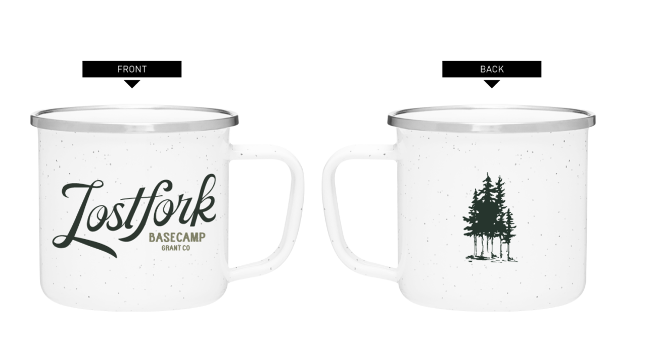 White speckled metal mug with a silver rim. The front has "Lostfork Basecamp Grant Co" in green text. The back features a green illustration of a cluster of pine trees.